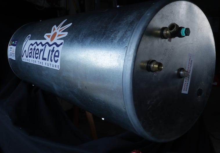 People show peace signs at a demonstration with green ribbons and backdrop cranes.