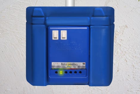 People show peace signs at a demonstration with green ribbons and backdrop cranes.