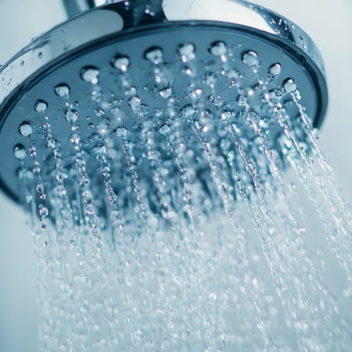 A stunning view of the golden sun shining through clouds at sunset, casting a warm glow.